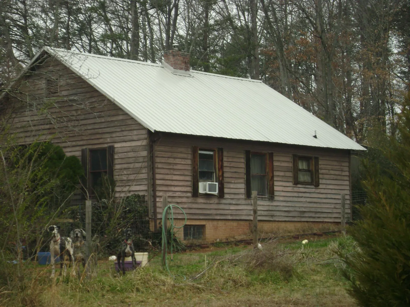 White metal roof on an old wood sided farmhouse, from a Metal Roof Installation job in Losantville